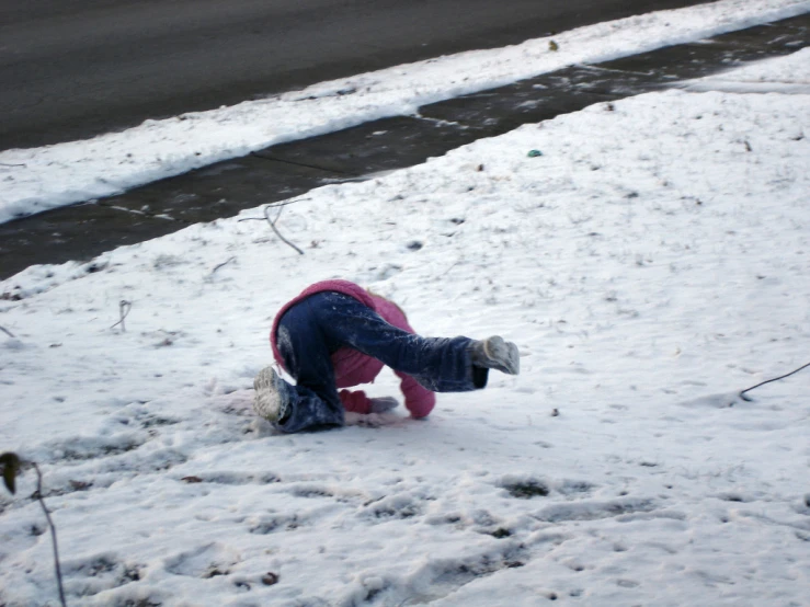 a child trying to get into the snow on the ground