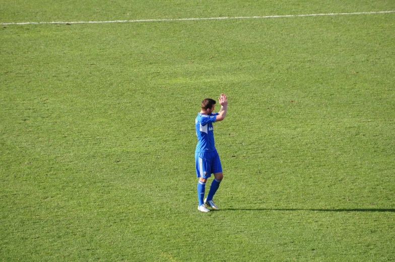 a young man on the grass playing soccer