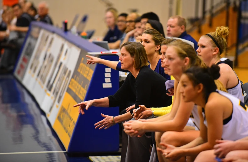 a coach talks to his players on the sideline