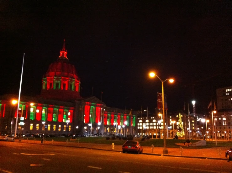 an evening view of a street with lights in the background