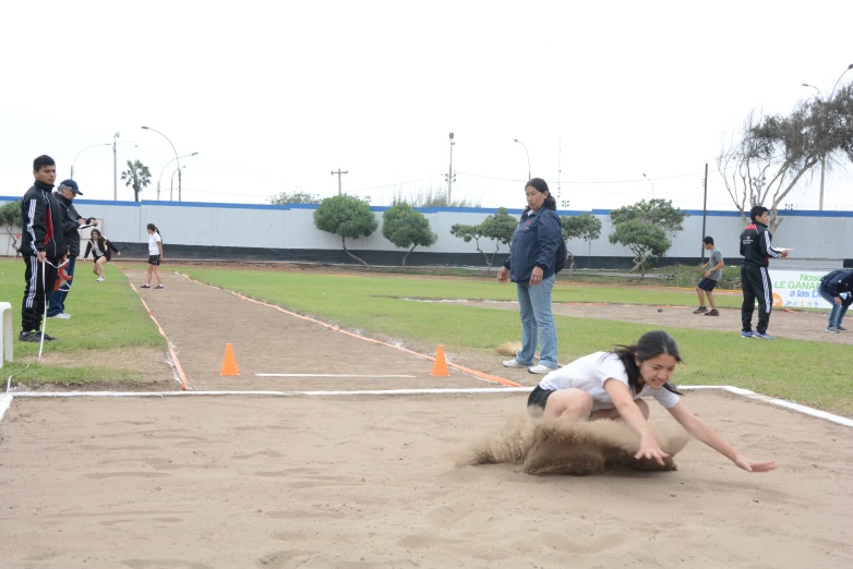 a woman rolling her foot in the dirt