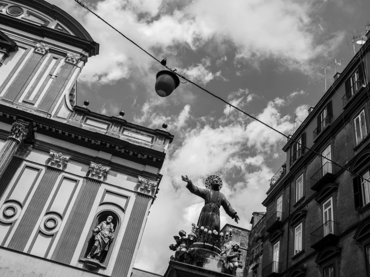 a building with some kind of statue hanging on it's side