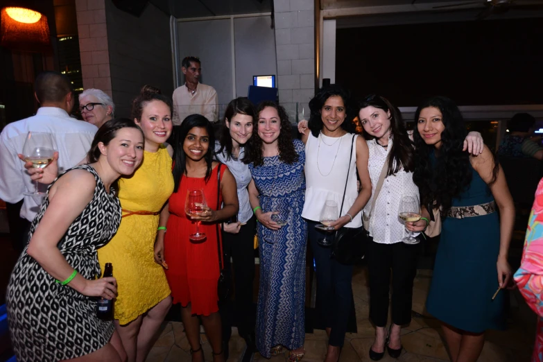 a bunch of young women pose for a group po