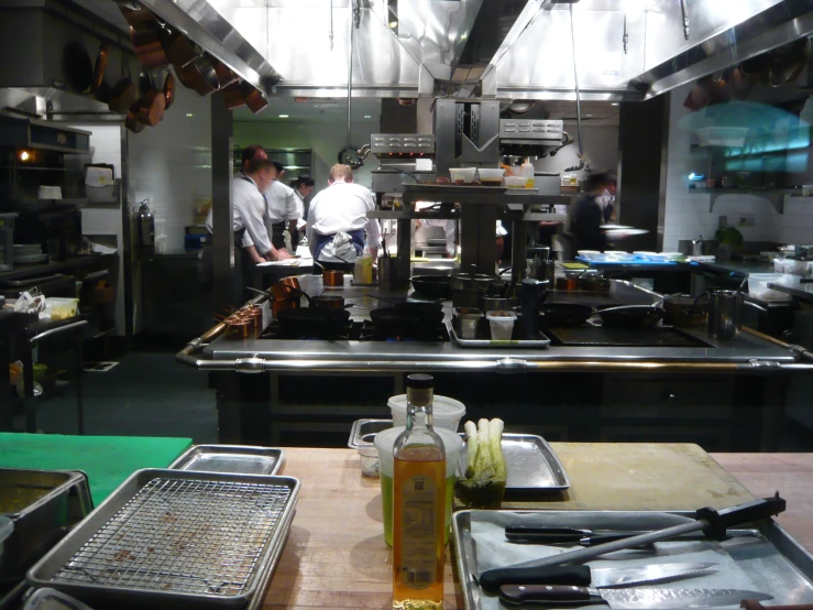 two chefs in an industrial kitchen preparing food