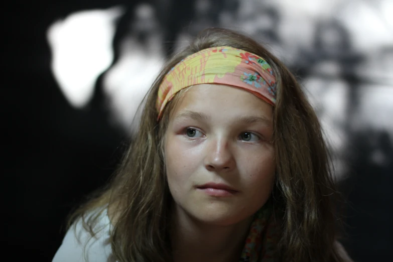 a girl has long hair with a flower bandana