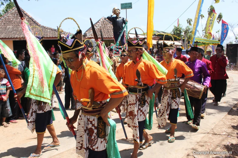 a group of people walking with costumes and holding flags