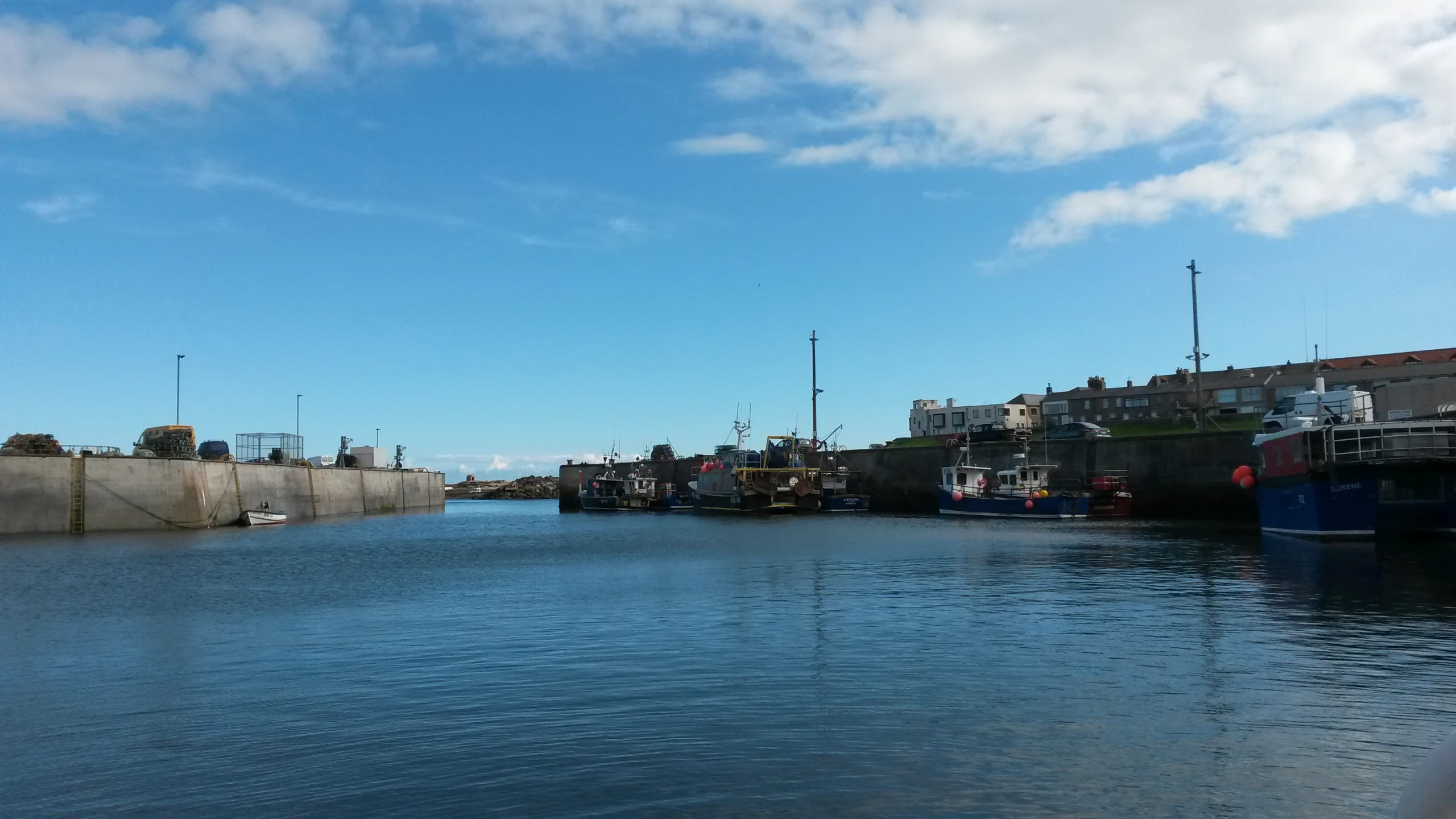 boats floating in a waterway under a blue sky