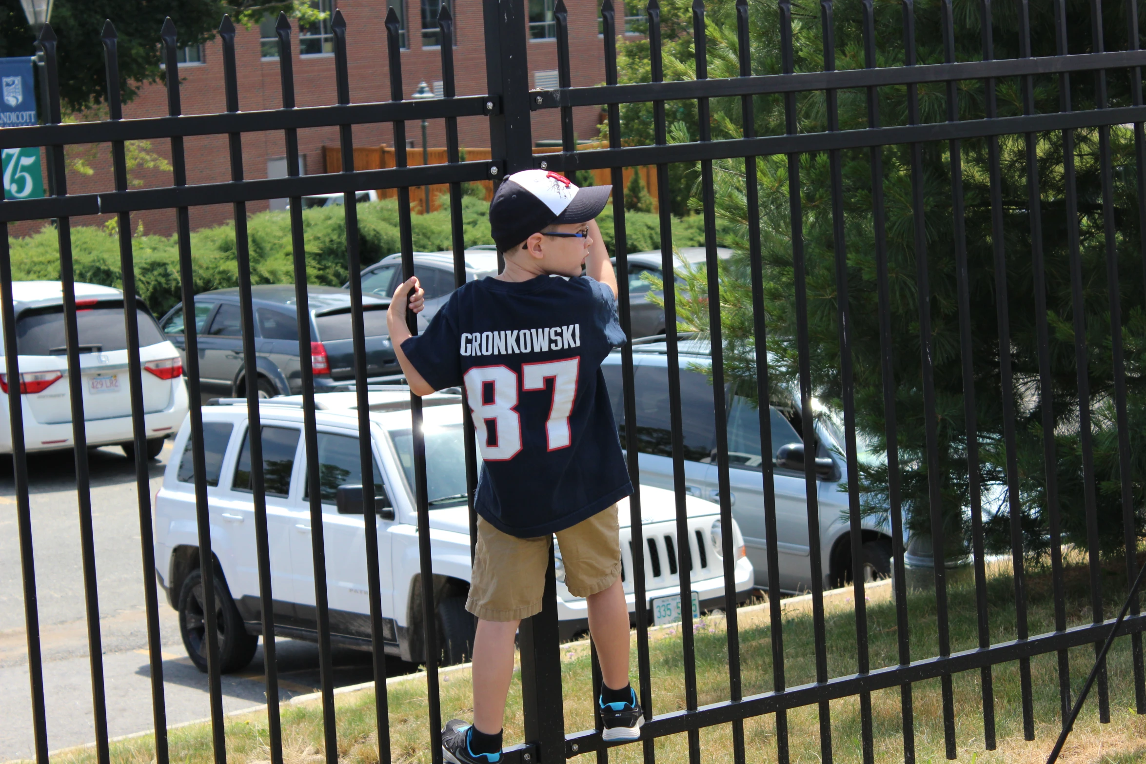 a  wearing a helmet is standing in front of some parked cars