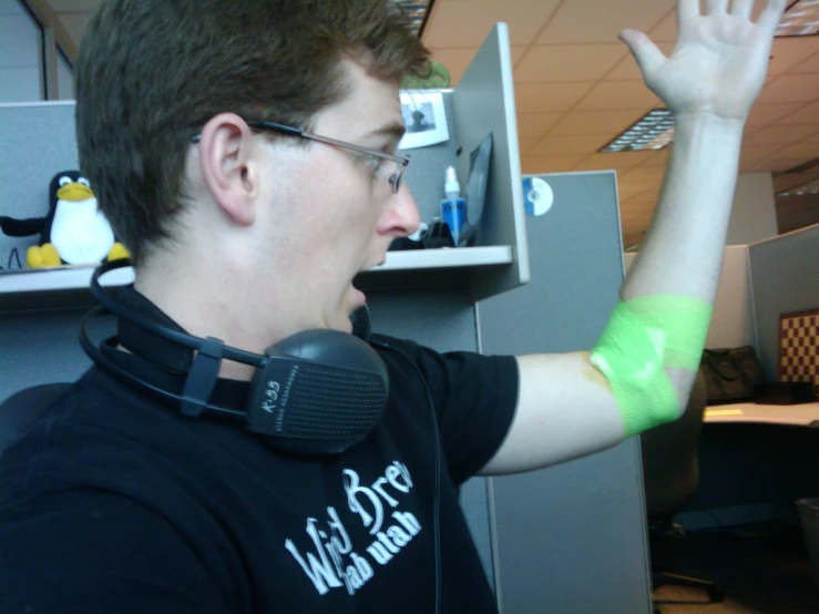 a young man is playing wii in an office