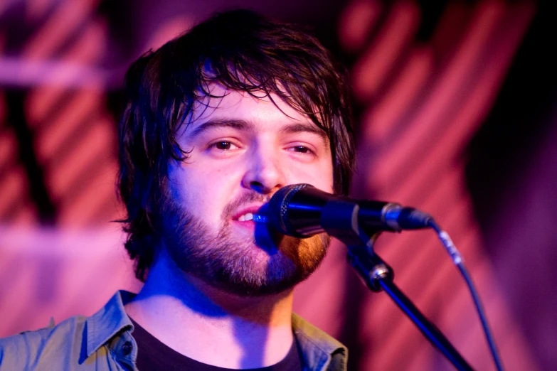 a man standing in front of a microphone