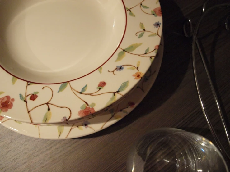 two dishes sitting on the table with a fork and glass