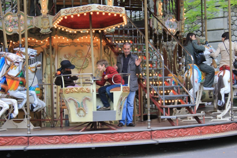 s on a carousel ride, with adults in costume