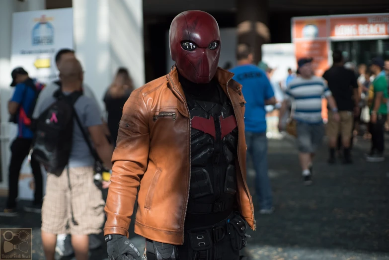 a man in a leather jacket holding onto a cell phone