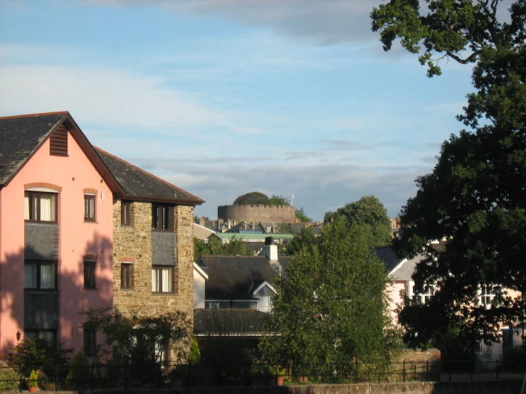 a few houses with a tower in the background