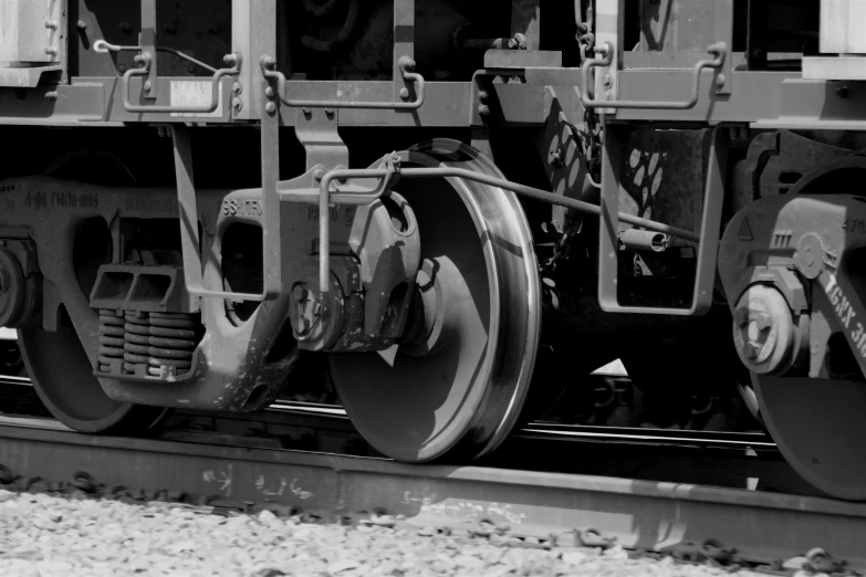 the wheels of a train with tracks in front of it