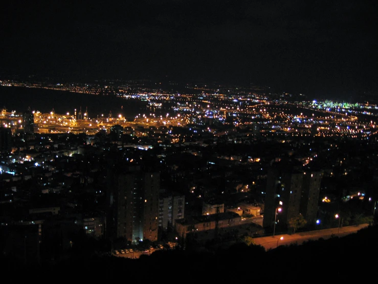 a night view of a city with buildings and lights lit up