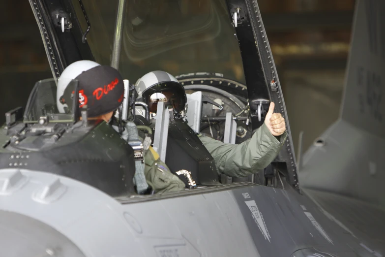 two people sitting inside of a large military aircraft