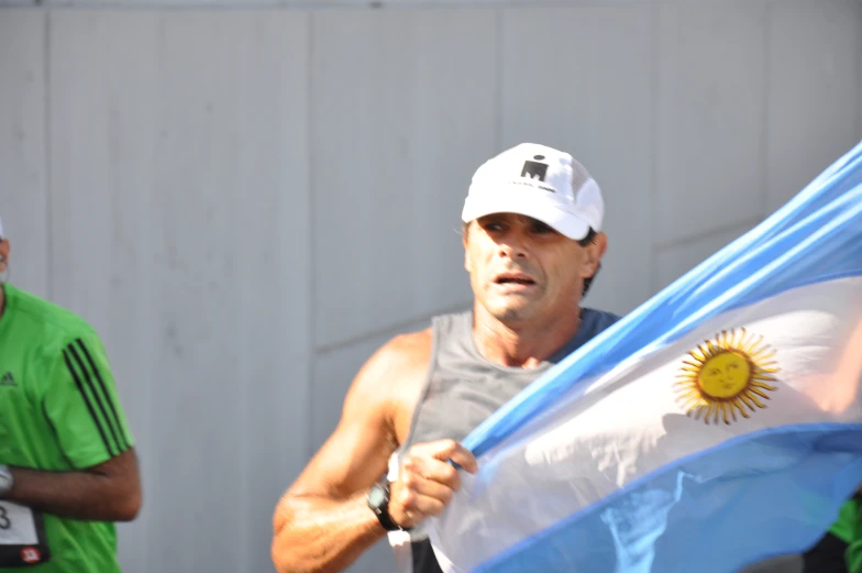 man with a flag in his hand at a race