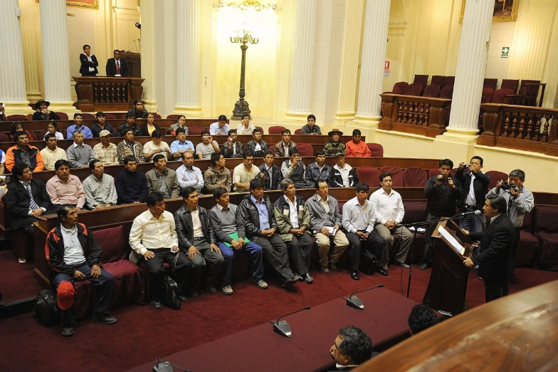 an audience of people standing in front of microphones