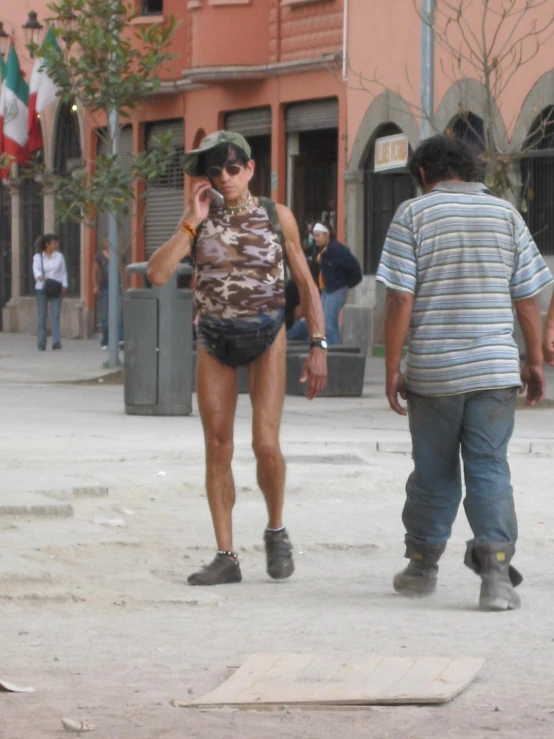 a woman in short shorts talking on a cell phone