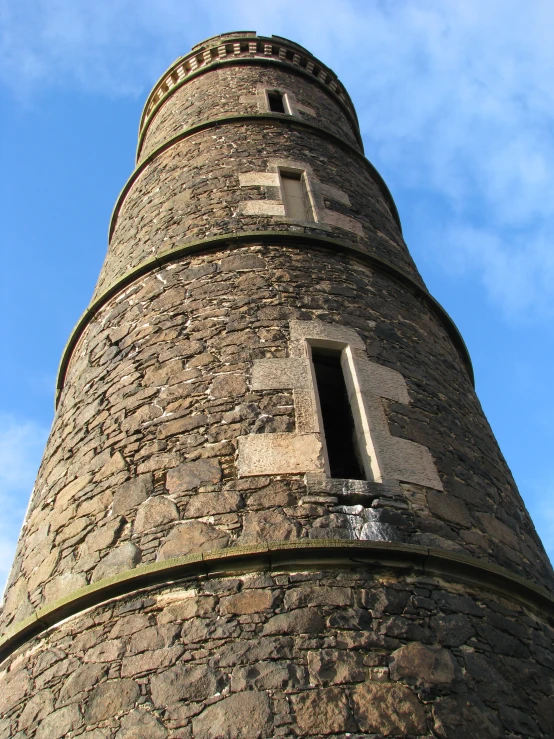 a stone tower built against a blue sky