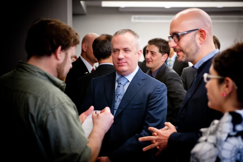 three men are standing next to each other talking