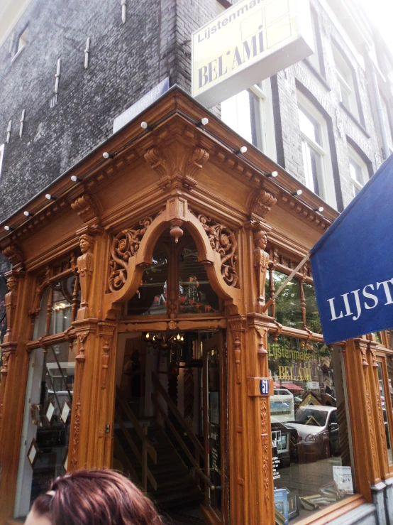 people are standing outside of a wooden building