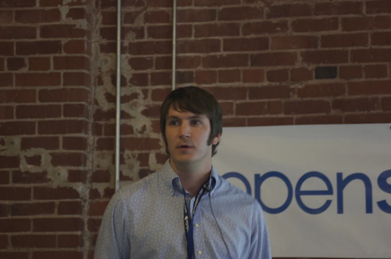 man wearing a neck tie by a wall