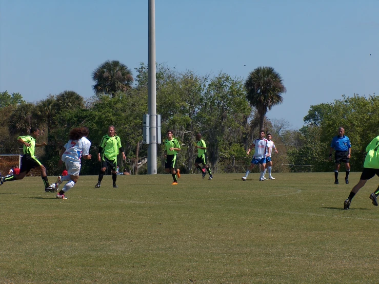 a group of soccer players playing a game of soccer