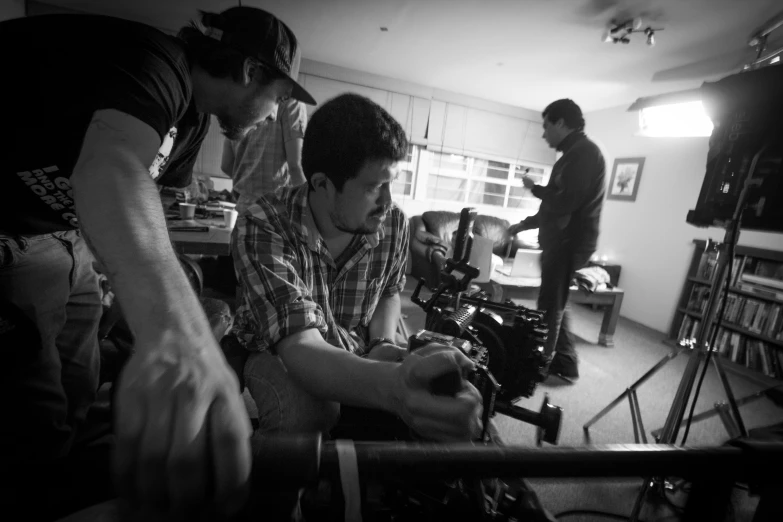 a group of men work together on crafts in a room