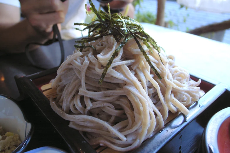 a meal of noodles with chopsticks and water