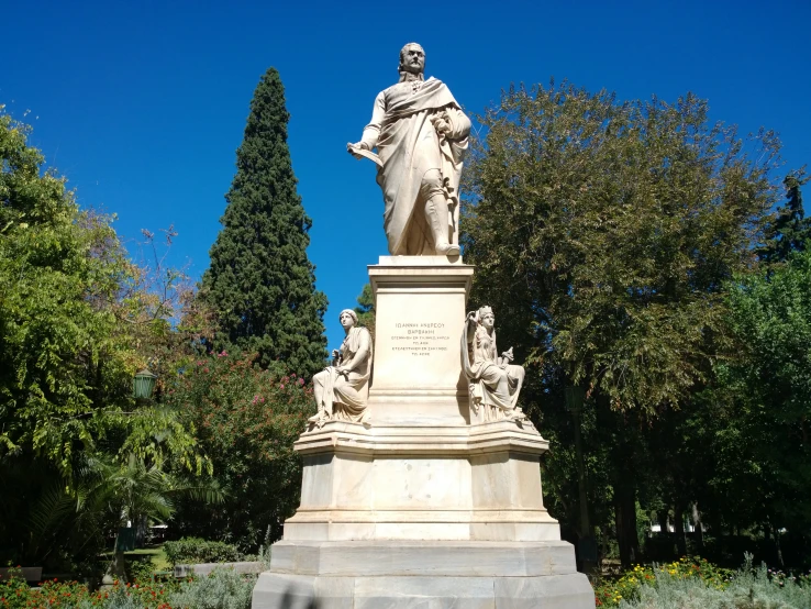 an image of the statue of jesus surrounded by trees