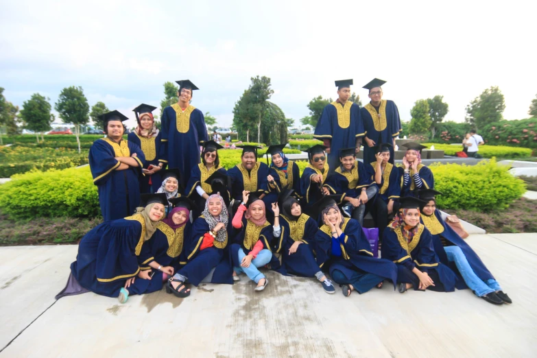 a group of graduating students with their diplomas posing for a po