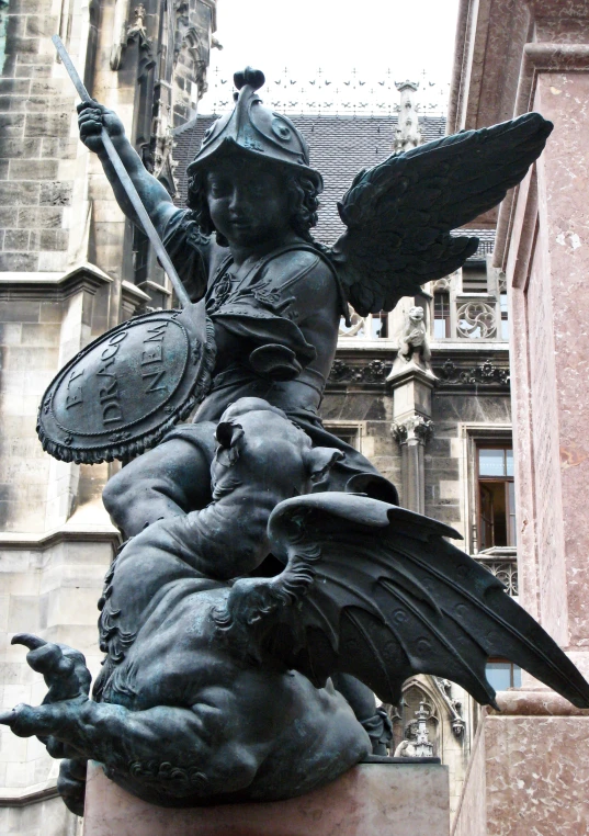 a statue in front of an old building on the street