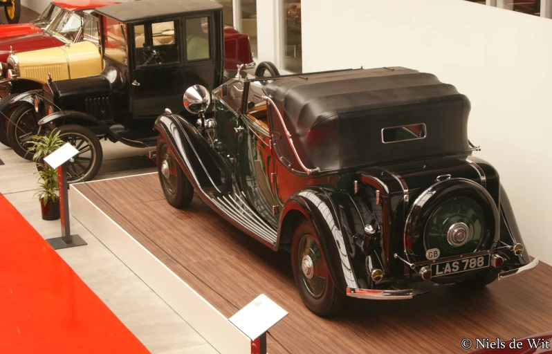 an old time car sitting on display in the store