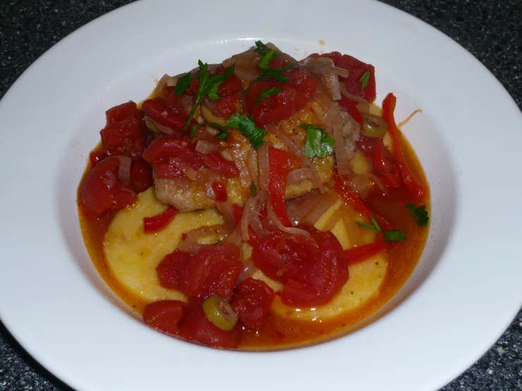 a plate with food containing meat and vegetables