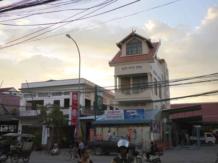 a city street is surrounded by buildings and telephone wires