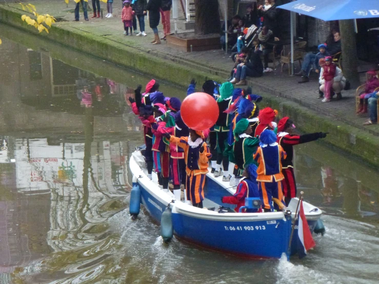 a large group of people riding in a boat on the river