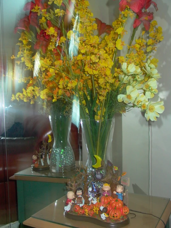 vases with flowers on a table with toys