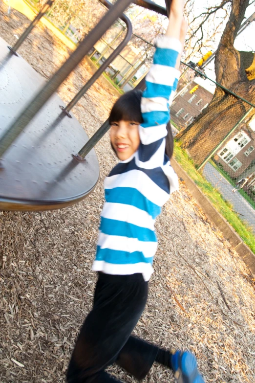 a  holds up a baseball bat in a park