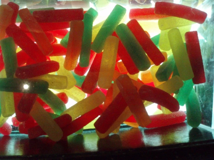 gummy bear candies sitting inside of a glass case