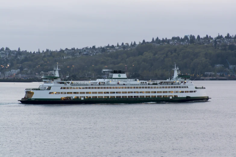 a large cruise ship is traveling along the water