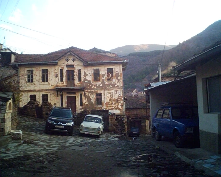 two cars are parked on the road near the building