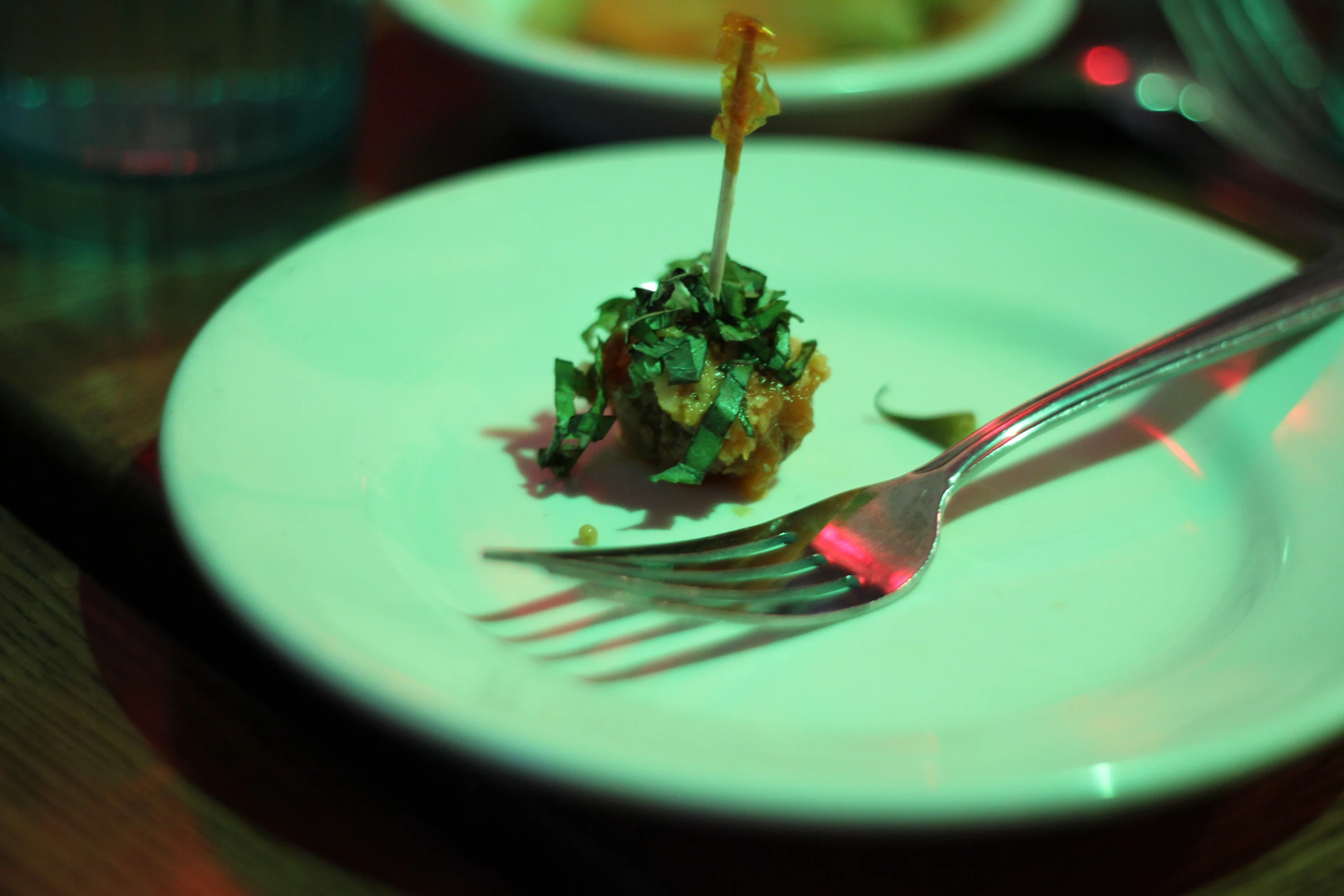 a piece of food on a white plate with a fork