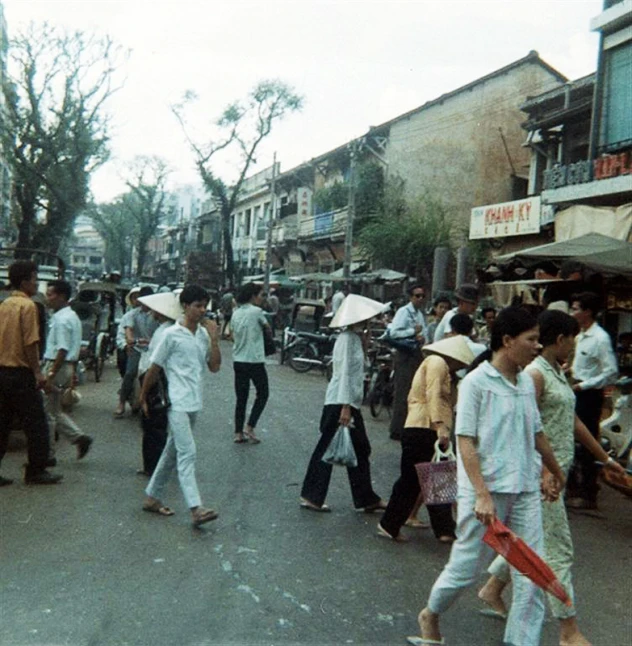 a large group of people walking down a street