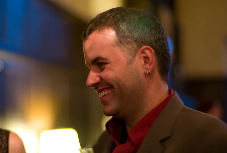 man in business attire standing at a bar