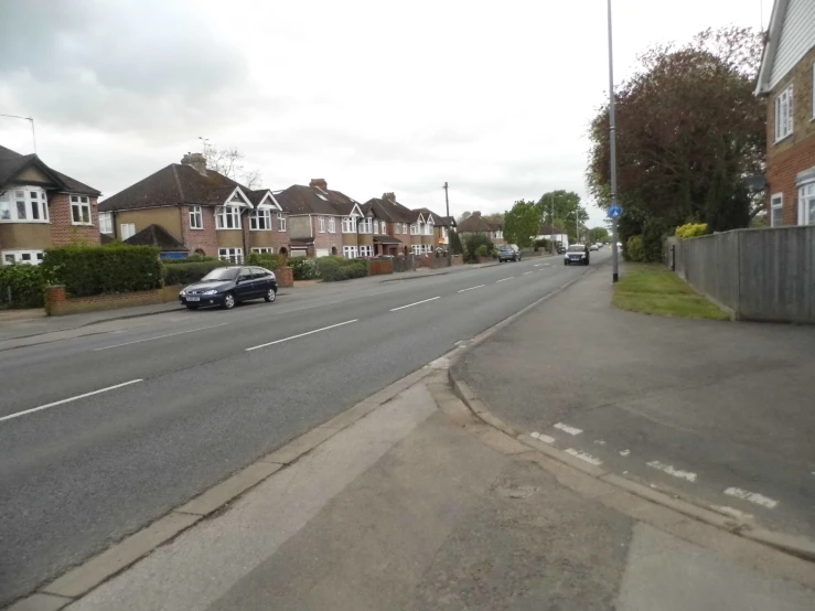 an empty street next to some brick houses