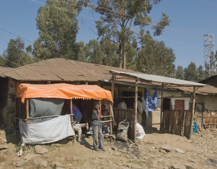 a family standing outside a house with tents