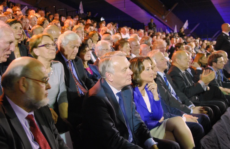 a large group of people sitting in chairs in front of them