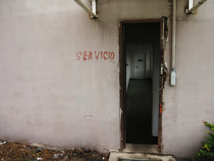 a doorway with graffiti on the walls and an opened door